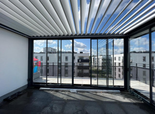 Louvered roof pergola with glass sliding walls and roller shutters on sides.Featuring LED RGBW lighting and IR heater.