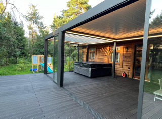 Modular system of two louvered roof pergolas fully enclosed by glass sliding walls