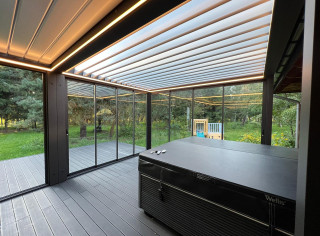 Modular system of two louvered roof pergolas fully enclosed by glass sliding walls