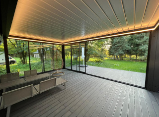 Modular system of two louvered roof pergolas fully enclosed by glass sliding walls