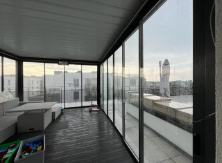 Louvered roof pergola featuring glass sliding walls and IR heater